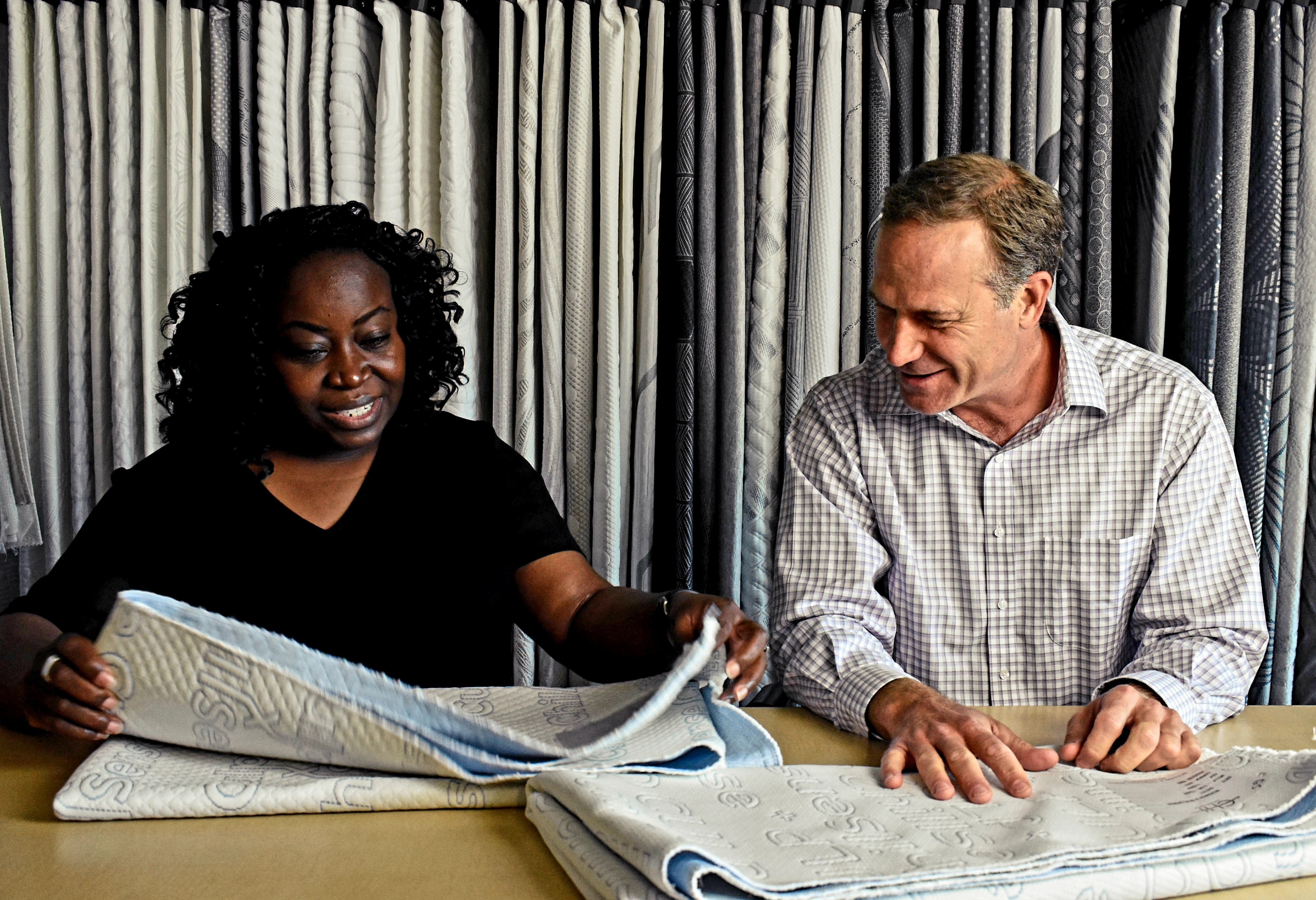 A photo of Christina and Jeff reviewing fabric